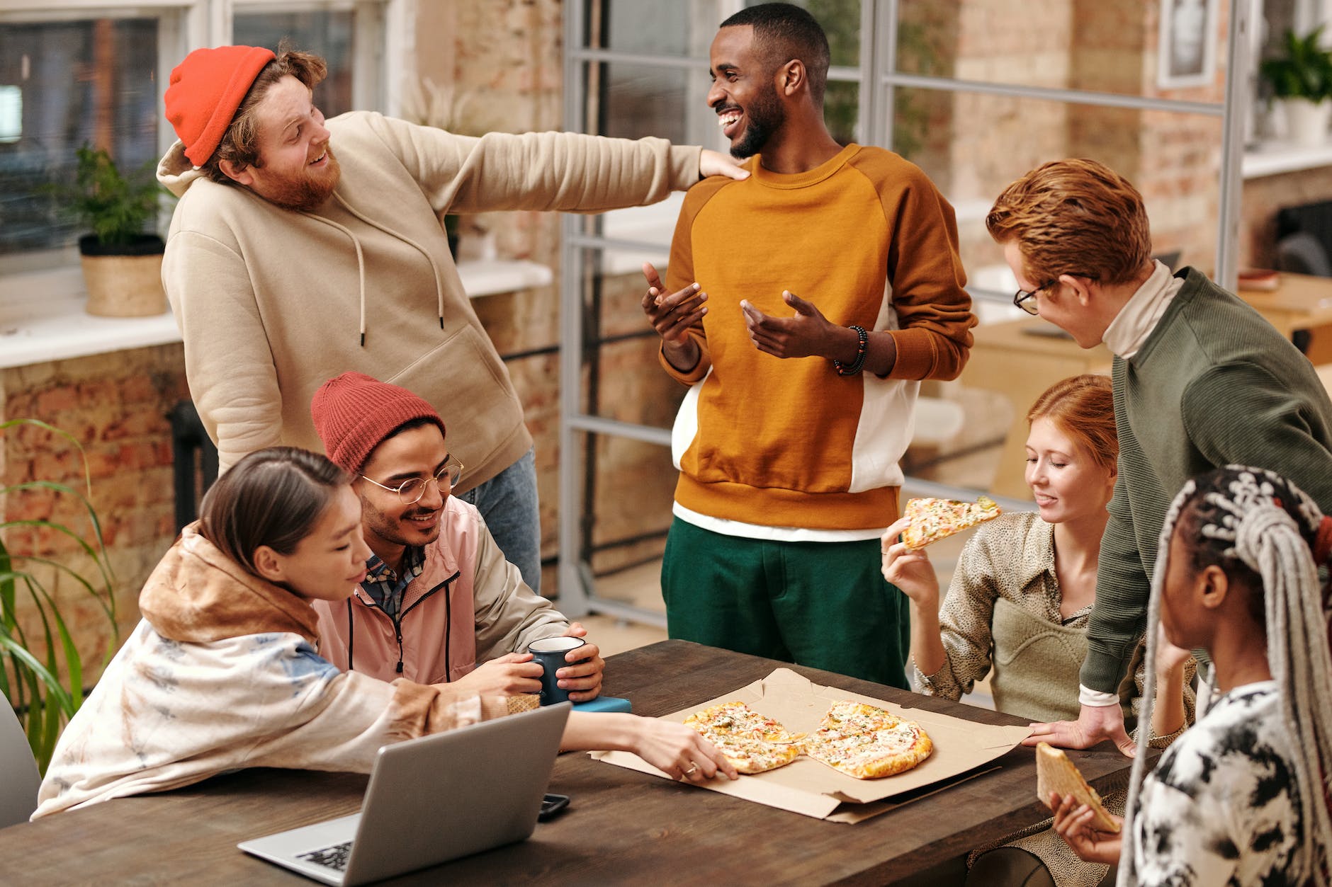 multiracial group of people by the table